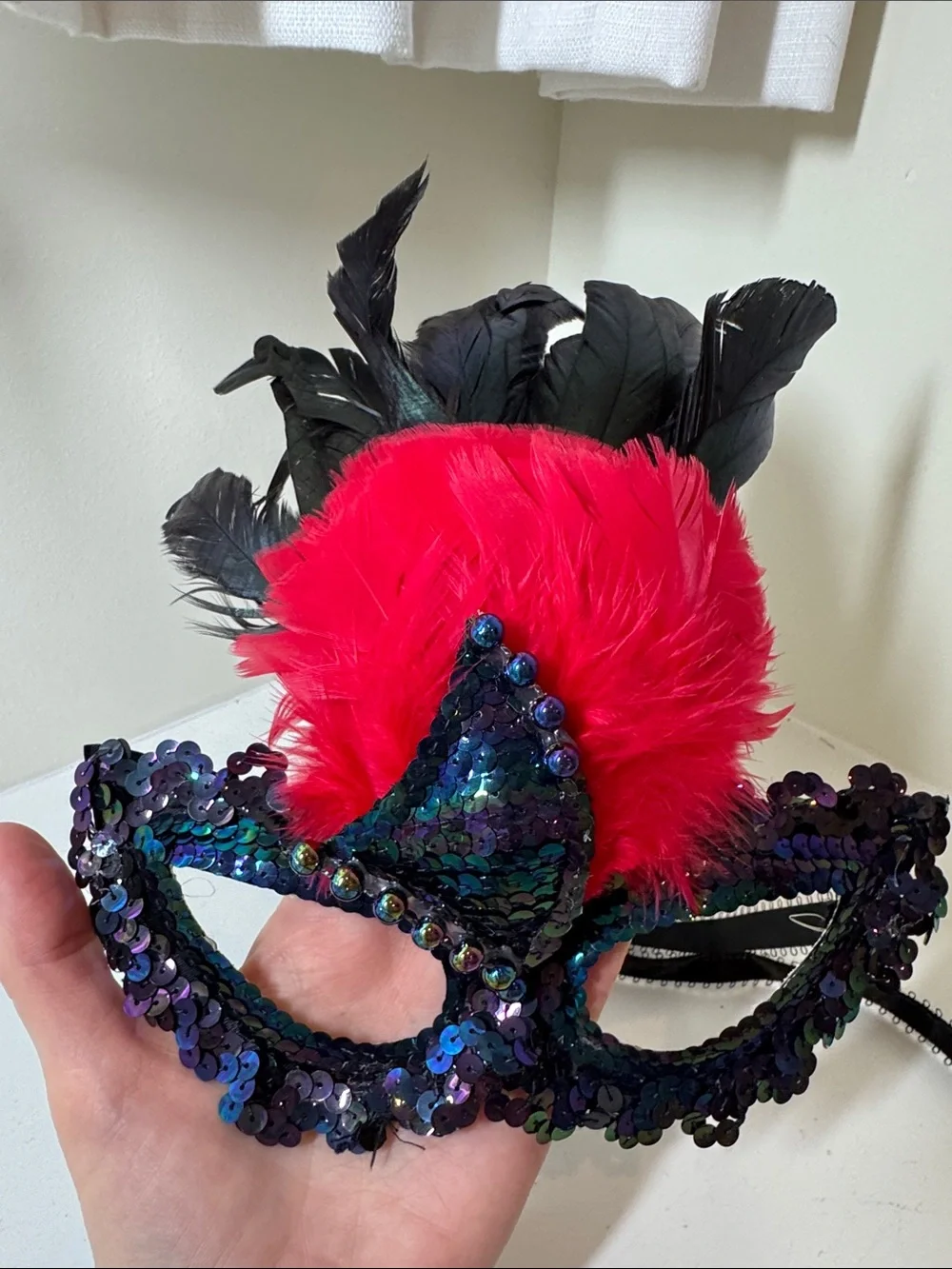Handmade sequined and feathered mask from New Orleans.